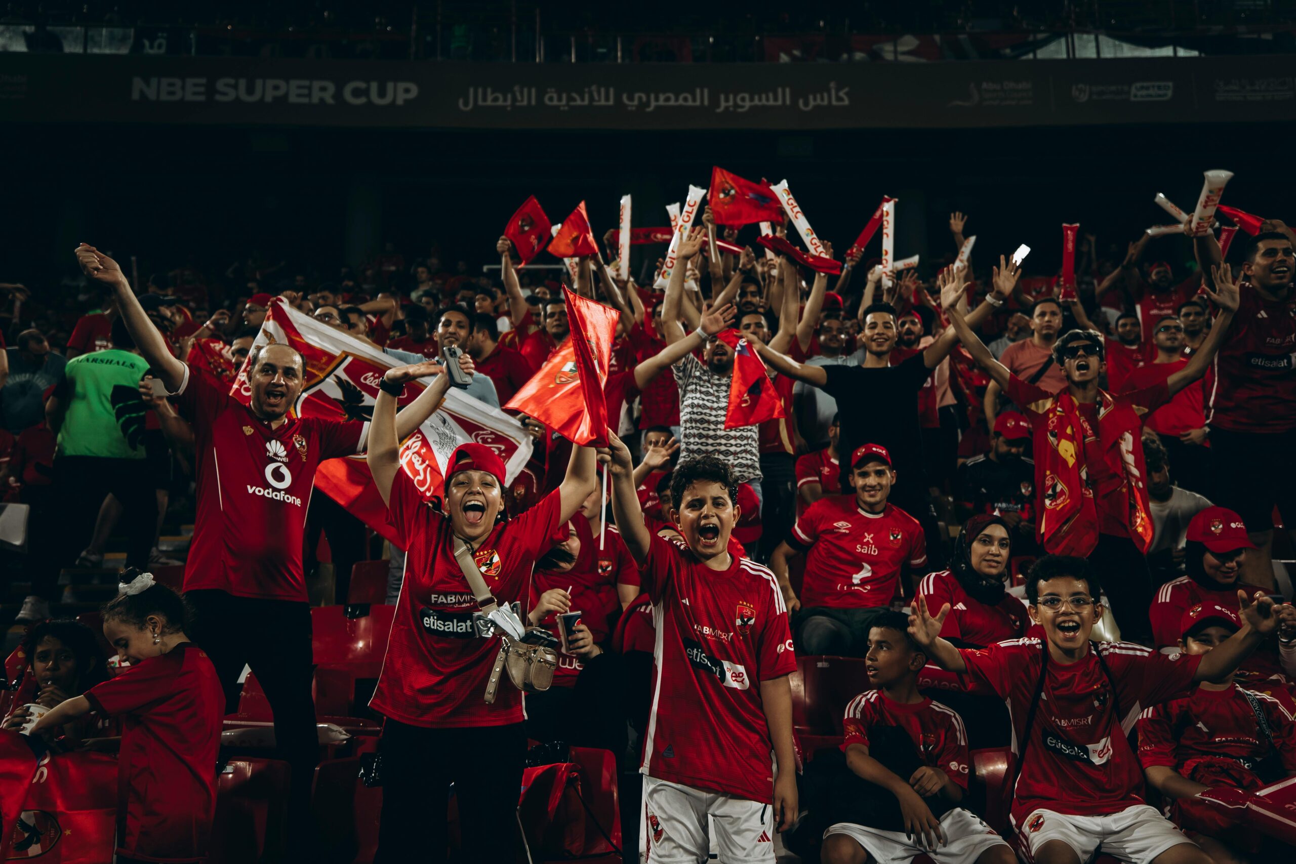 Passionate fans celebrating at the NBE Super Cup football match.